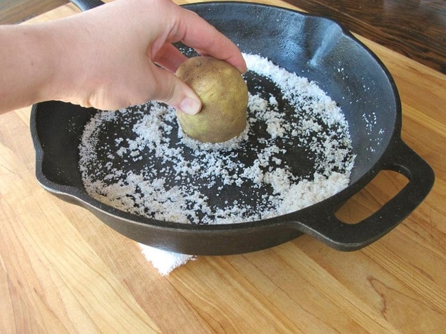 You can clean an old iron frying pan with the help of salt, oil, and potatoes.