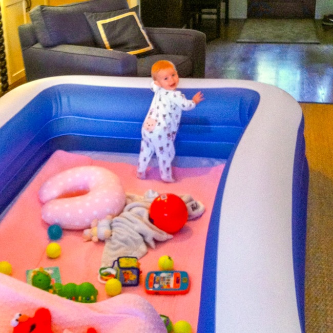 Use an inflatable pool to create a safe place for a baby to play.