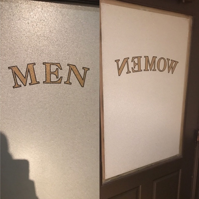 The bathroom door says, “men” from the outside but from the inside it says, “women” spelled backwards so you think you’re in the wrong bathroom.