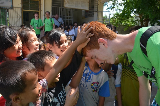These kids in China have never seen red hair before and asked to touch it.