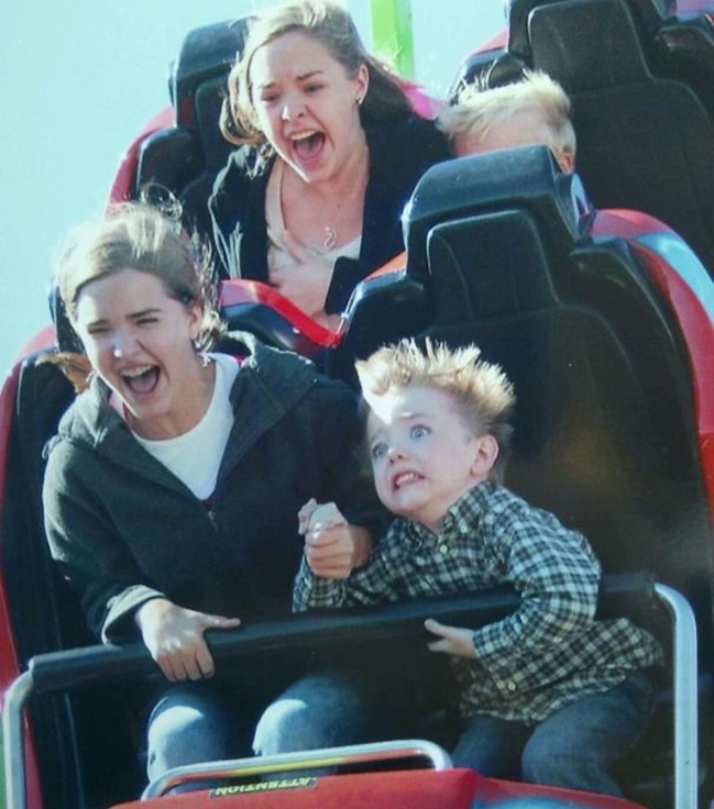 Young boy's first time on a roller coaster.