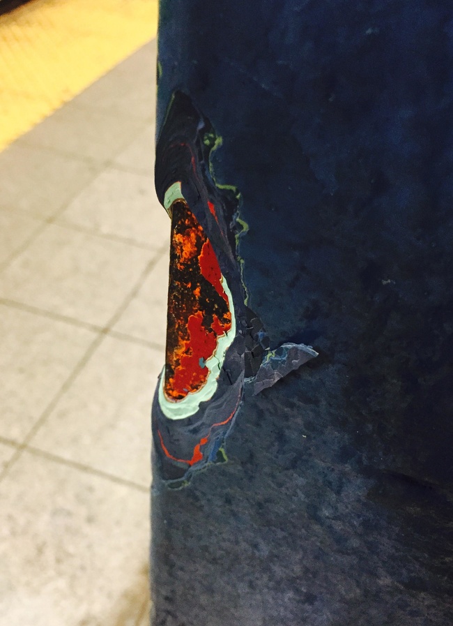 Layers of paint on an NYC subway pillar