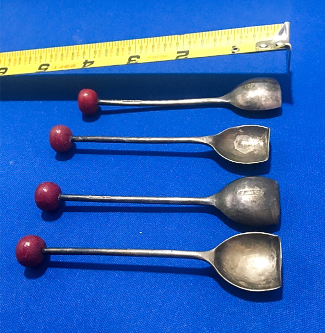 These are vintage cocktail spoons. You could use it to squash a cherry in your drink.