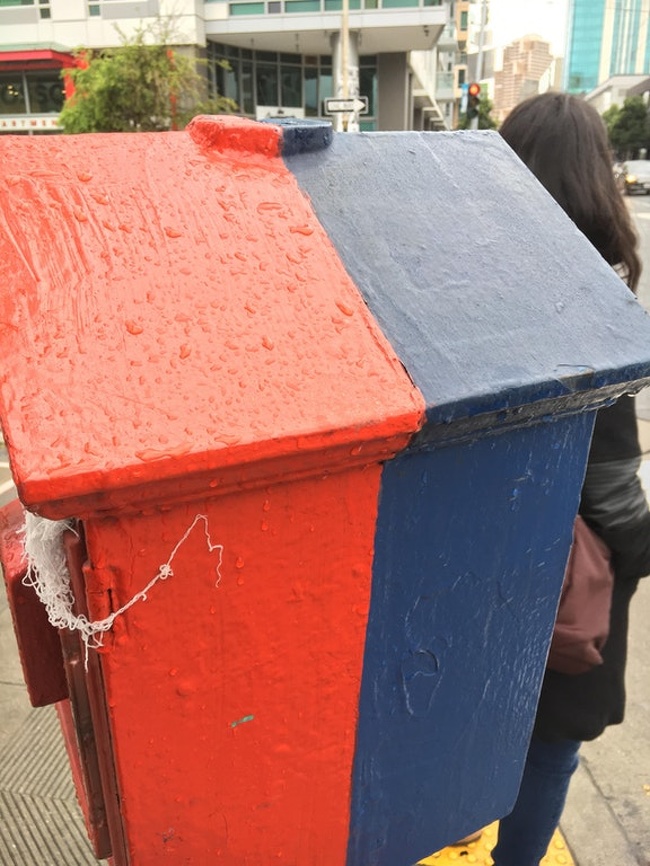 The rain rolled off the blue paint, but stuck to the red.