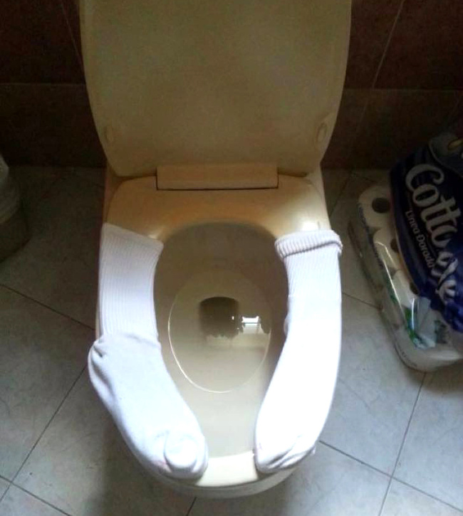 If you don’t enjoy sitting on a cold toilet seat, just use your socks.