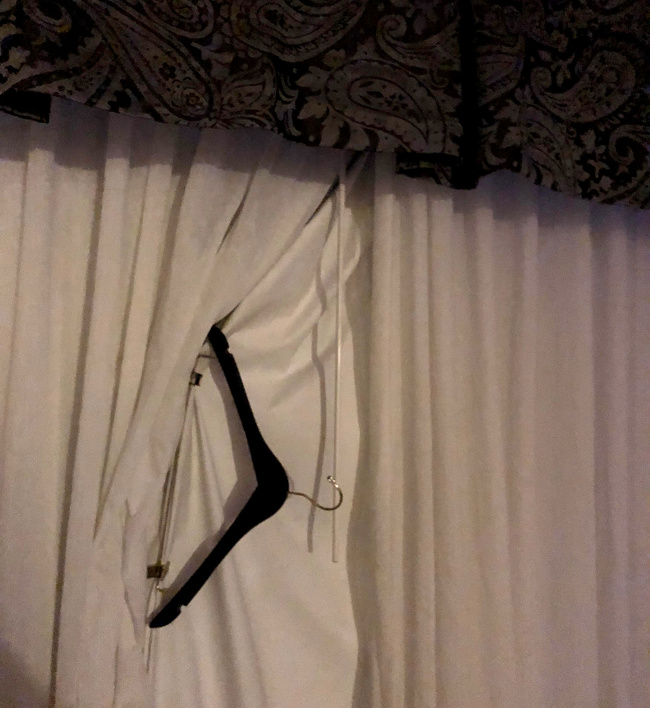 If the hotel curtains don’t block the light out, use a hanger with clips to keep it shut.