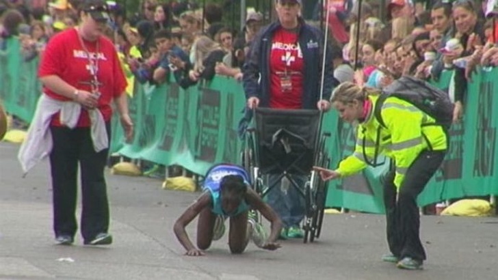 A participant in the Austin Marathon is crawling across the race’s finish line.