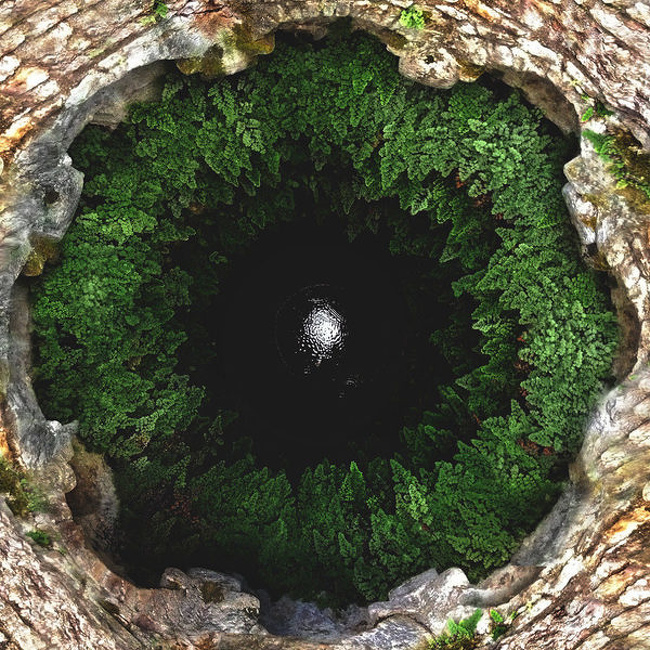 A deep hole with a lake on its bottom, Italy