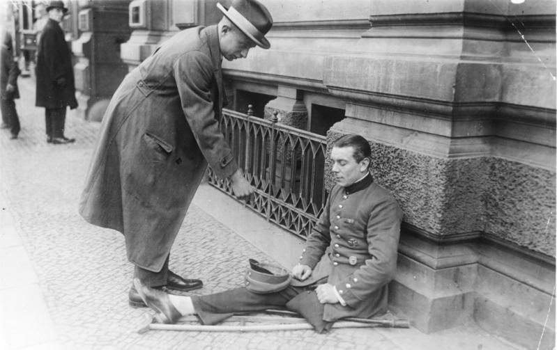 A WWI veteran is begging on the streets of Berlin, Germany in 1925.
