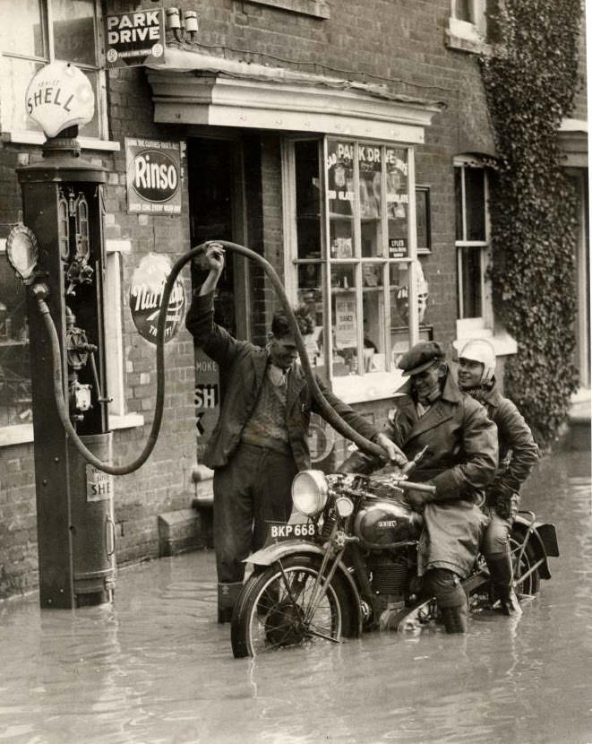 Getting gas during a flood in England in 1935.