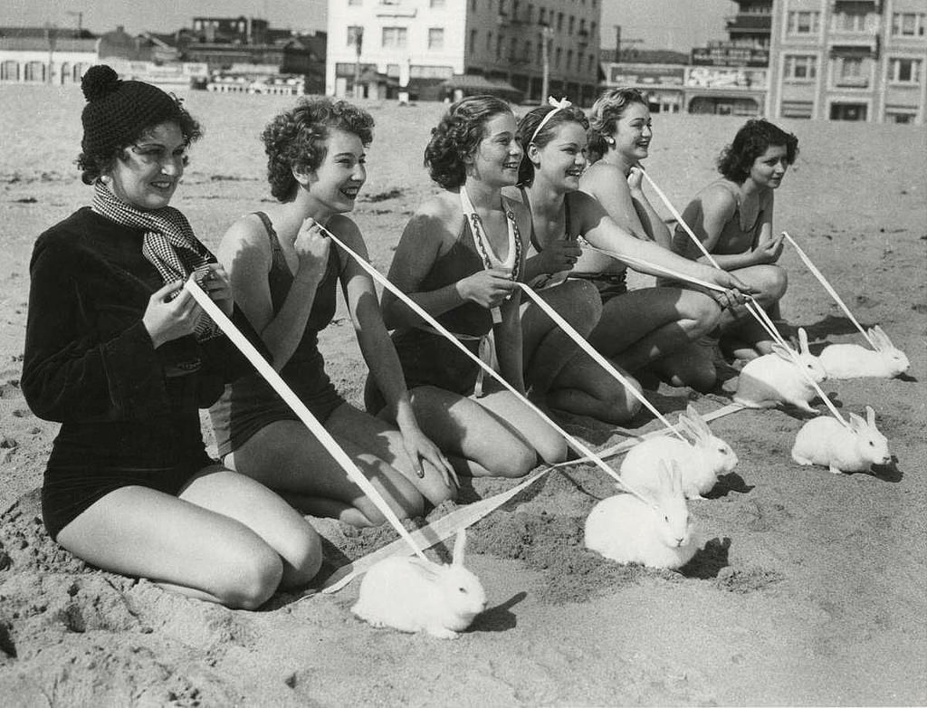 Models take their pet rabbits to the beach in California, US in 1937.