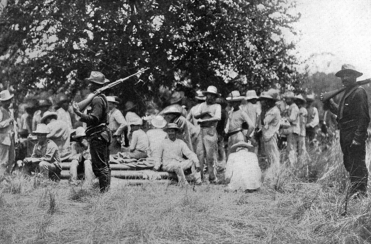 Black soldiers known as Buffalo Soldiers guard captured Spanish prisoners during the Spanish American War in Cuba in 1898.