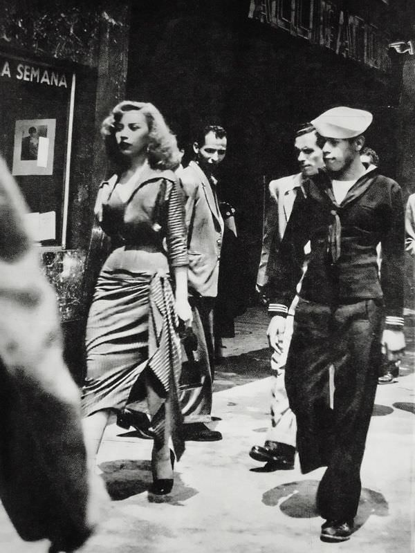A women being watched and harassed in Mexico City, Mexico in 1950. There are 5 pictures of her being watched by men everywhere she went.