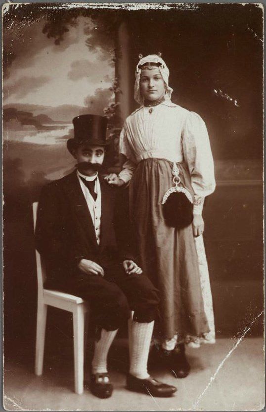 A couple swap clothes to pose as each other for some fun in the Netherlands in 1905.