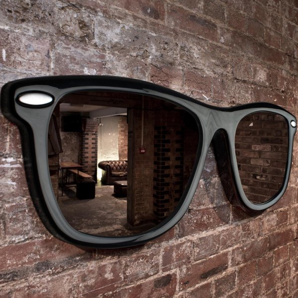Massive sunglasses mounted on a brick wall in an apartment as a wall decoration