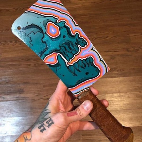Butchers knife with a psychedelic skull painted on the blade