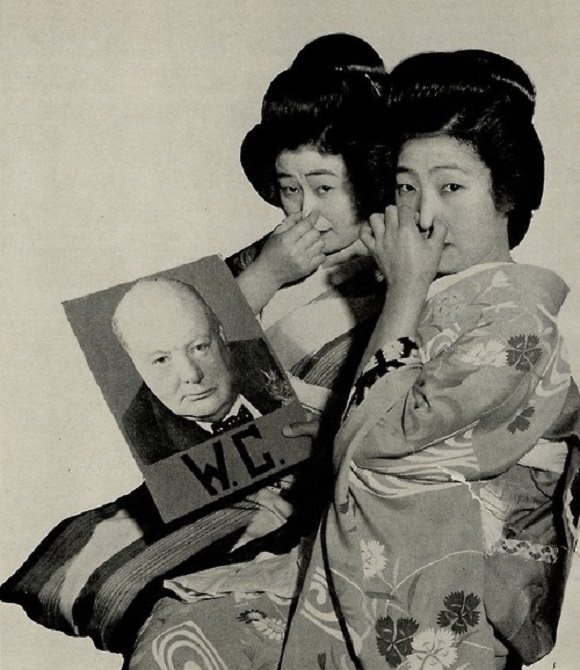 2 Geishas react to seeing Winston Churchills picture in Japan in 1940.
