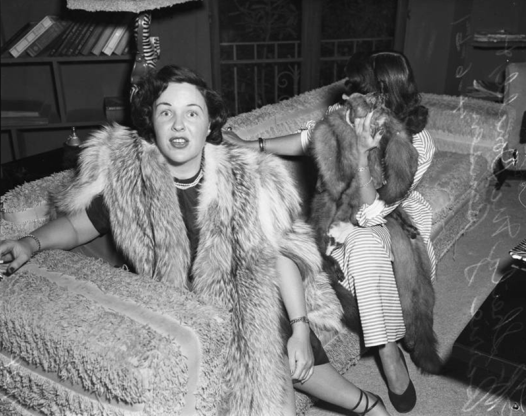The different reactions of 2 suspected prostitutes being photographed during a police raid in Los Angeles, US in 1951.
