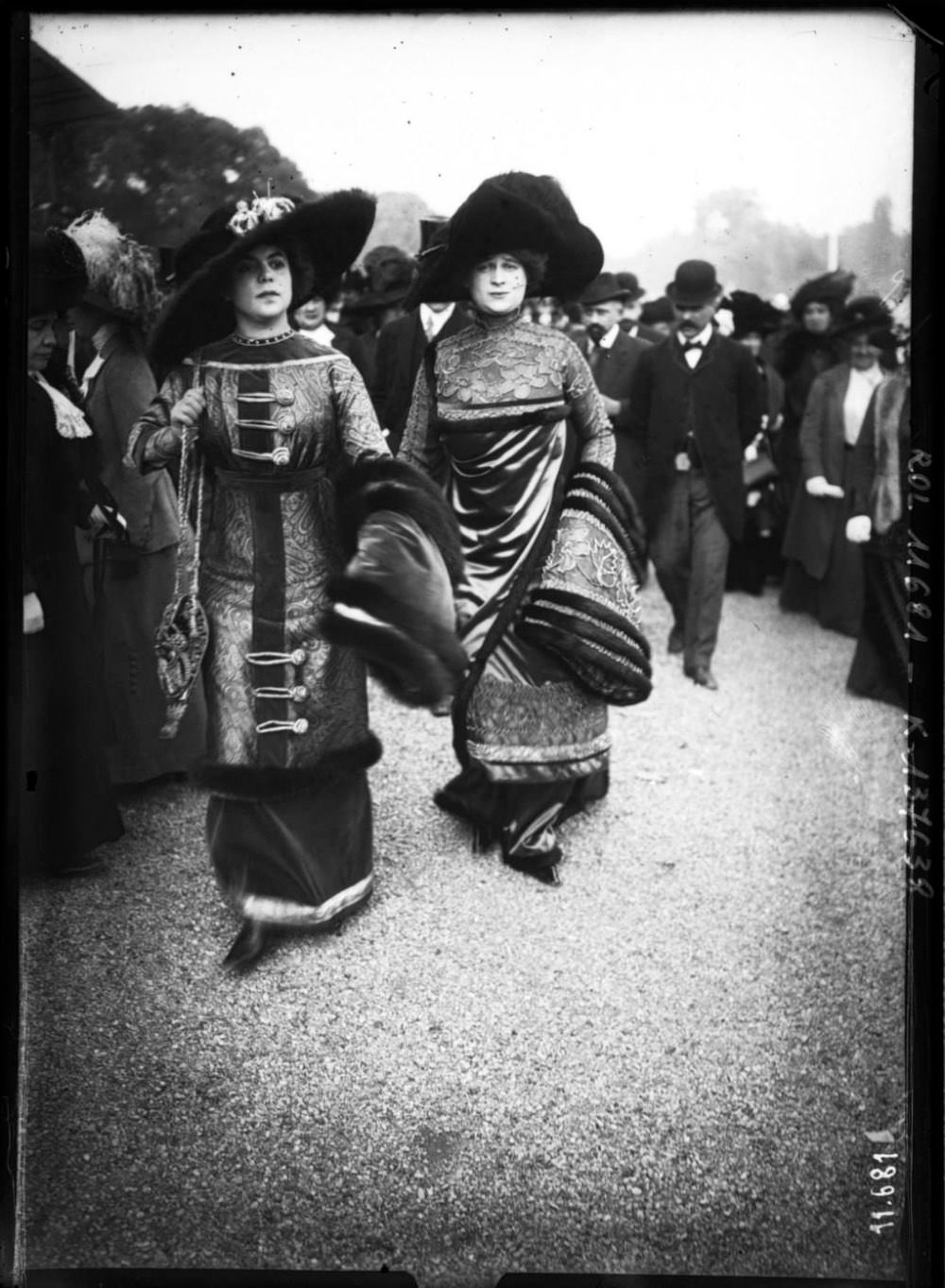 2 Men dressed as women showing off some unique fashion in Paris, France in 1910.