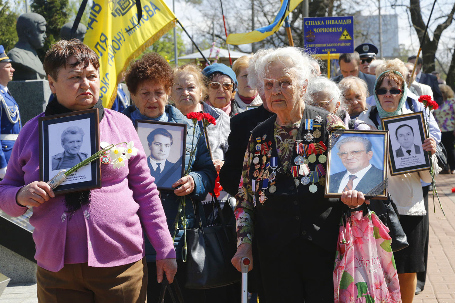 chernobyl victim wives hold pictures of their beloved husbands