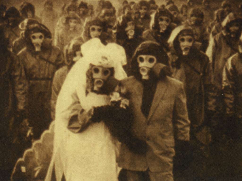 2 People get married at Miyakejima Island, Japan in 2000. The island is full of toxic gas from high level of volcanic activity, and most of the 3,600 people had to evacuate earlier that year. These people however, stayed for that special day. (not that old a picture, but way too good not to add)