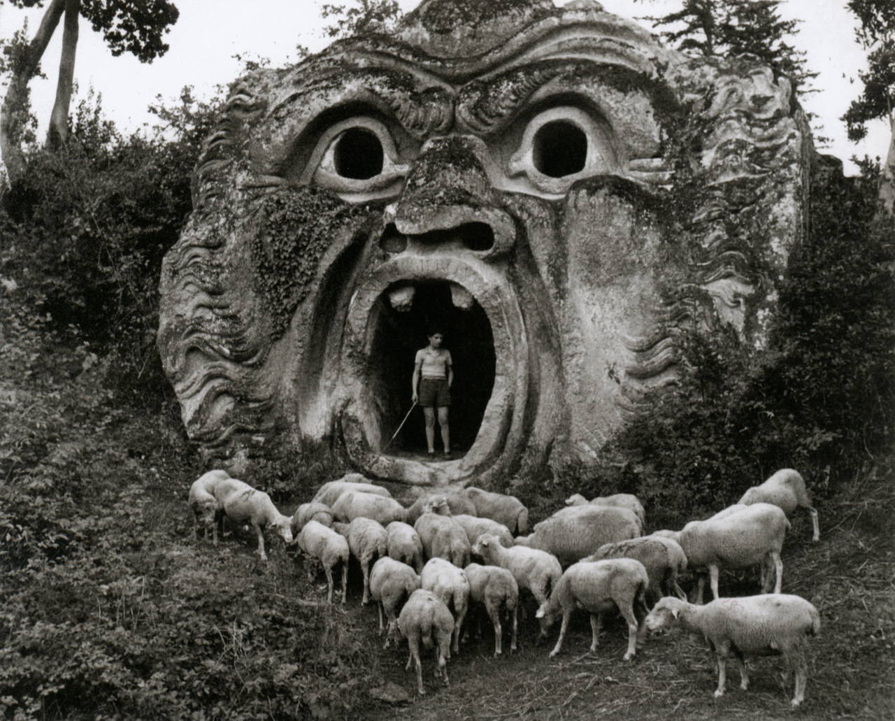 A woman shepherds her herd at the abandoned Park of Palazzo Orsini in Bomarzo, Italy, in 1952.