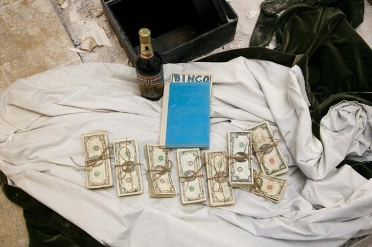 A couple found a 50-year-old safe hidden in their kitchen wall containing $51,080, a bottle of bourbon, and a book.