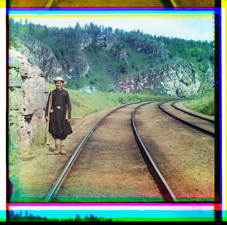 A switch operator poses by the Trans-Siberian Railroad, Russian Empire, 1910 in rare, original color.