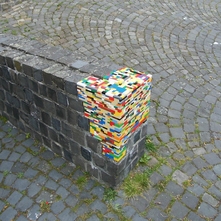 A crumbling old cobblestone wall restored with Legos