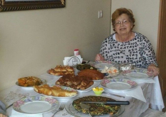A Turkish grandmother proudly shows off a meal she cooked, before having a heart attack.  Her family called an ambulance only nine minutes after taking this photo.