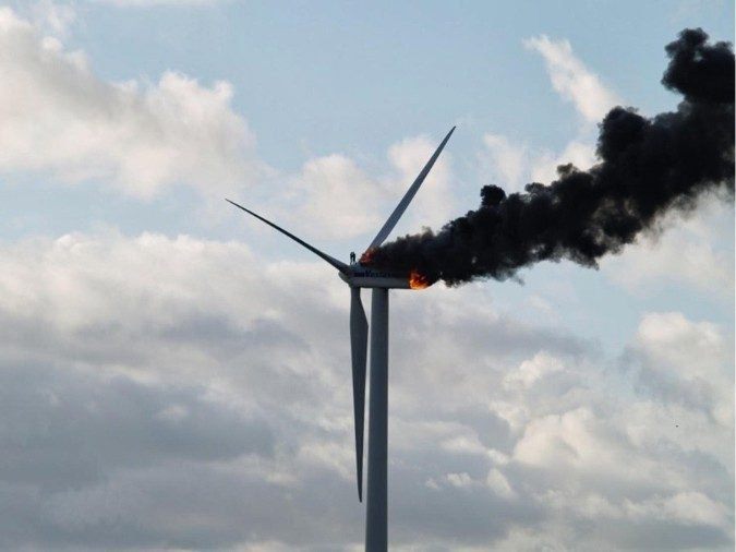 Two engineers stand on a burning windmill. In the Netherlands, two engineers were performing maintenance on a wind turbine when it caught fire. Their only escape route became blocked. One worker jumped off the turbine, the other burned to death.