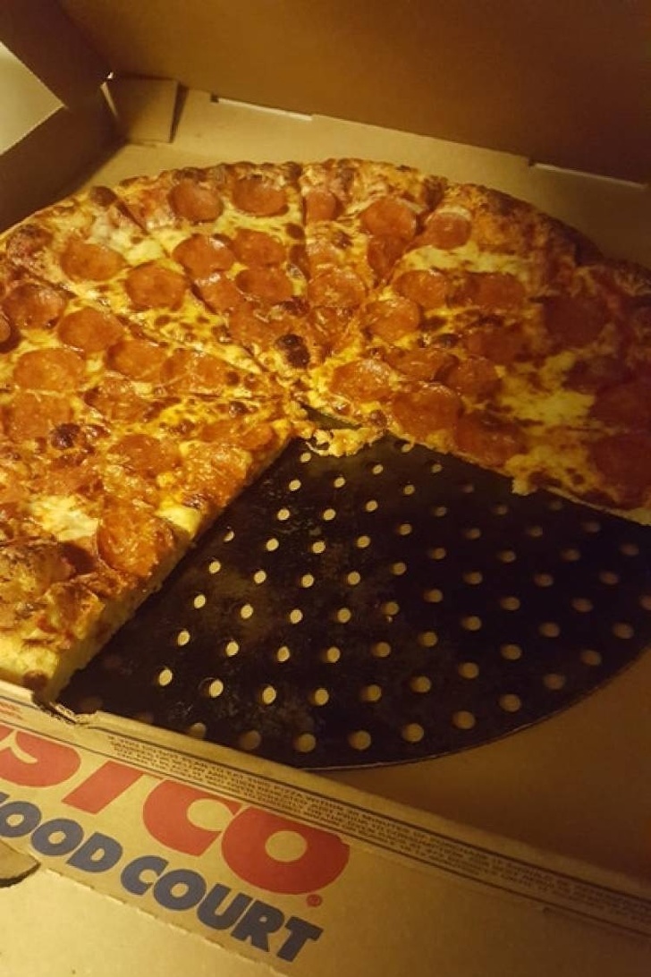 The pizza guys forgot to remove the pan from underneath the pizza.