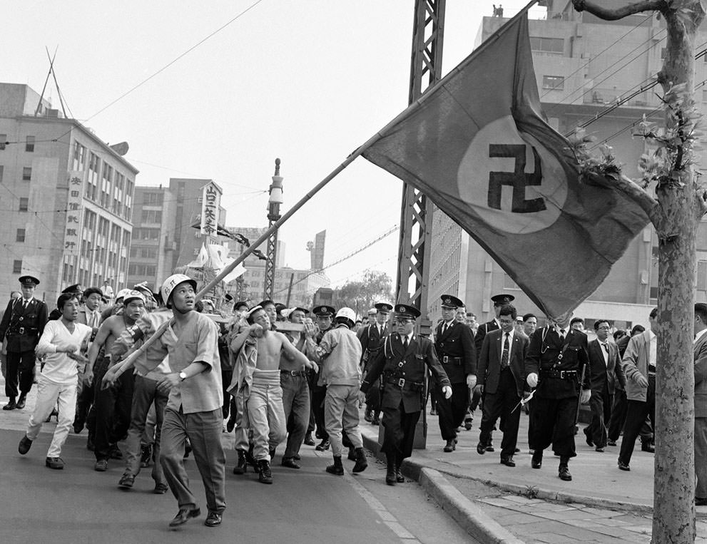 Workers march behind the Nazi banner during a workers rally in Tokyo, Japan in 1961. They wanted the dissolution of the Socialist Party and for it to be replaced with an Ultra Nationalist party very similar to National Socialists (Nazis).