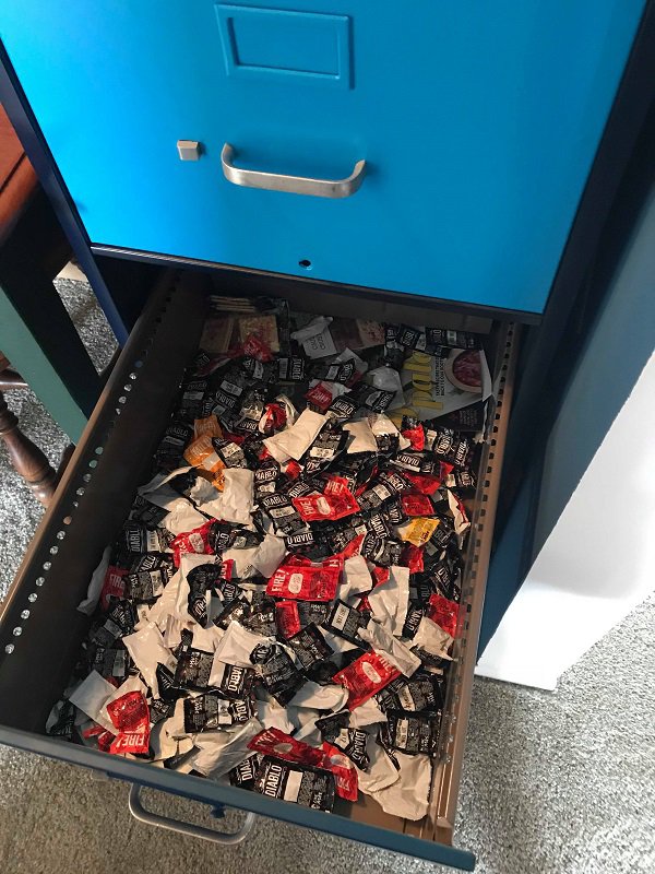 A drawer full of taco bell sauces.