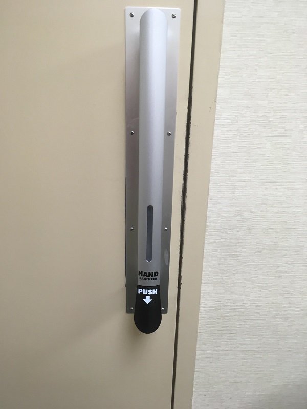 Hand sanitizer on a door handle.