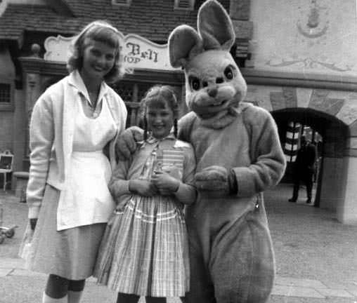 A family takes a picture with a rabbit character at Disneyland in 1958.