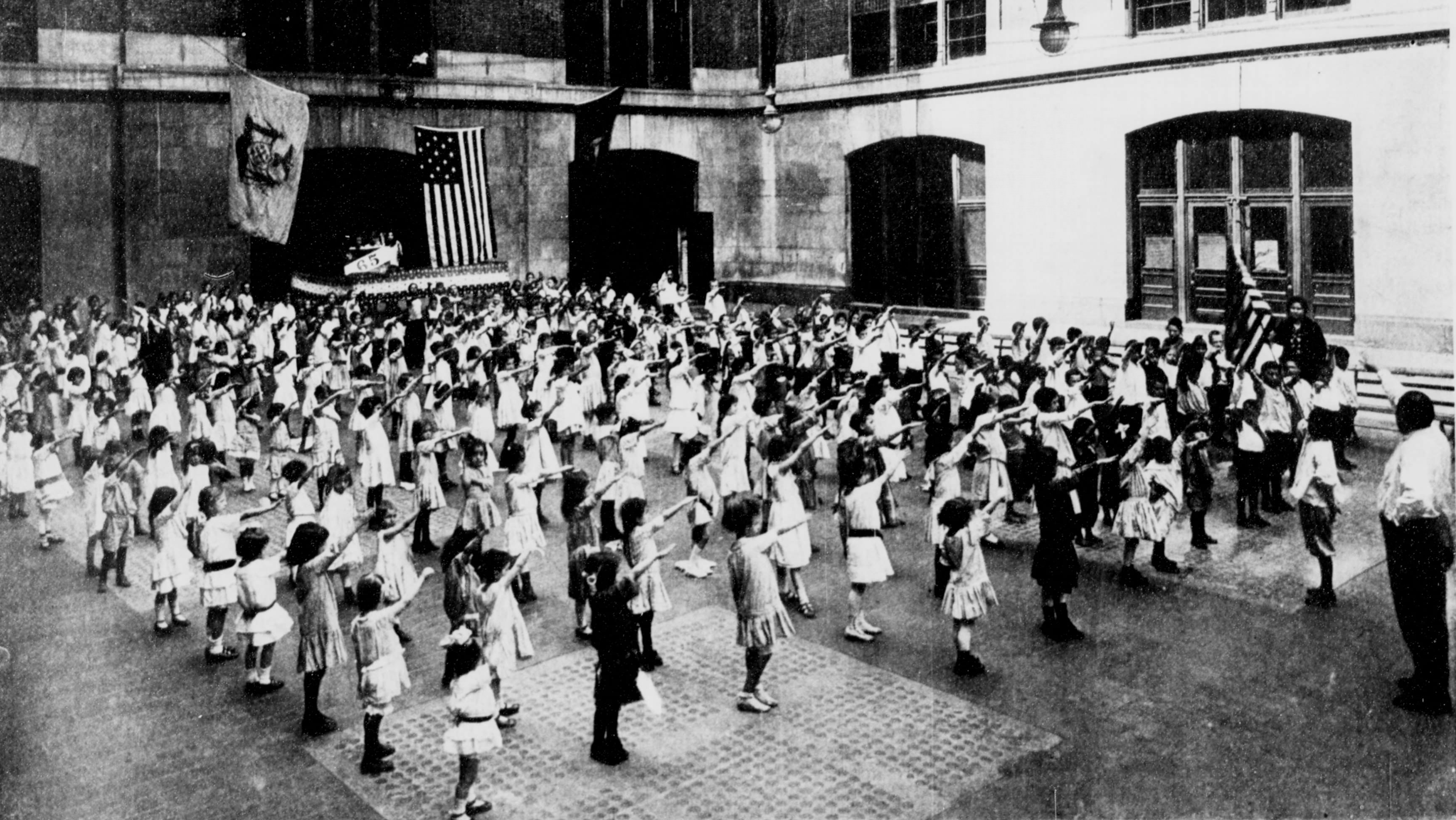 School children salute the flag in the US in 1915. This was known as the Bellamy salute, and was the same as the Nazi's salute well before the Nazi's existed. Once Germany became an enemy to the US, the Pledge of Allegiance salute was formally changed.