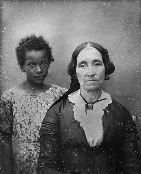A woman takes a portrait with one of her child slaves in New Orleans, US in 1850.