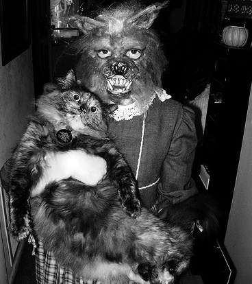 A girl in her Halloween costume with her cat in the US in 1968.