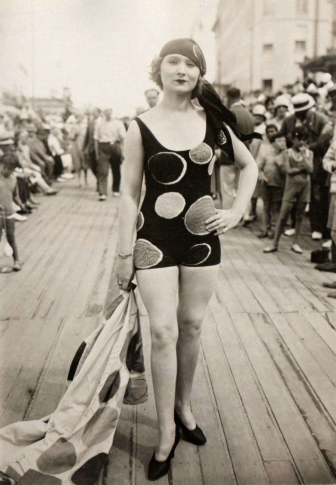 A woman shows off her bathing suit in France in 1930.
