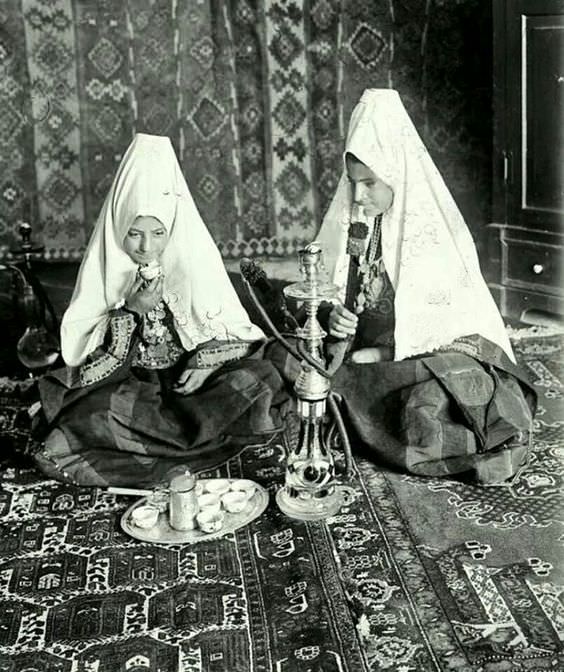 Young ladies smoking a hookah and drinking tea in Palestine in 1931.