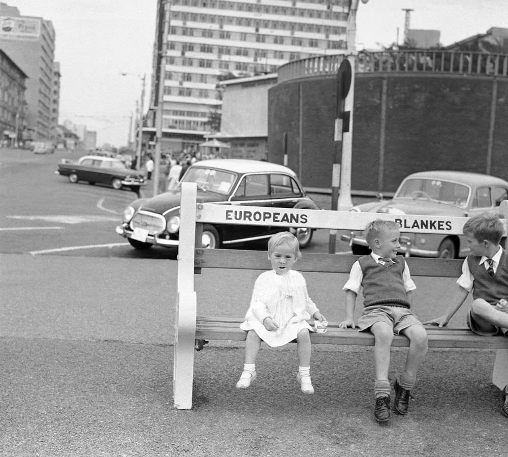 Kids sit on a white only bench in South Africa in 1958.