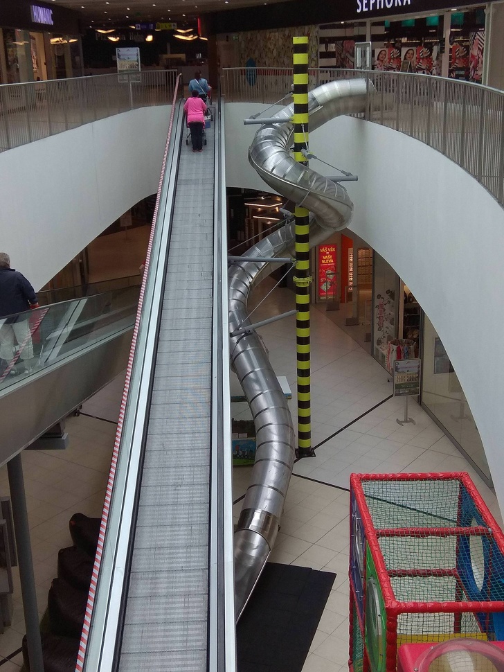 You can take a slide instead of the escalators at this mall in Prague.