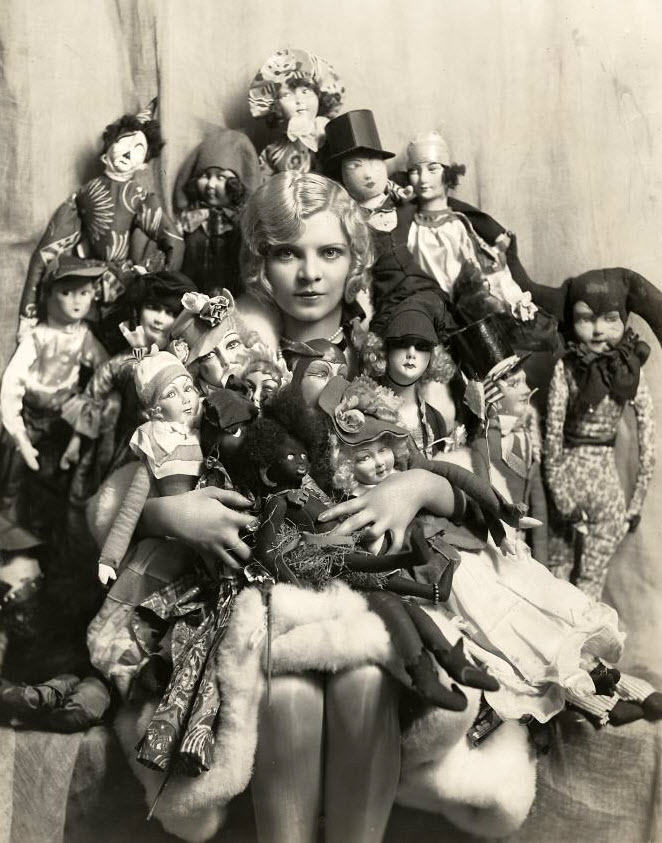 A flapper girl and her many boudoir dolls in France in 1924.