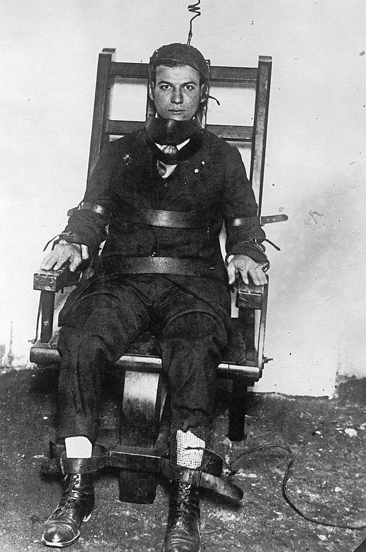 A convicted murderer sits in the electric chair prior to his execution in the US in 1925.