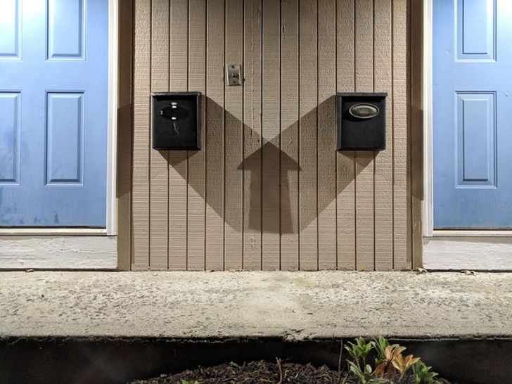 The shadow of two mailboxes makes a perfect “up” arrow.