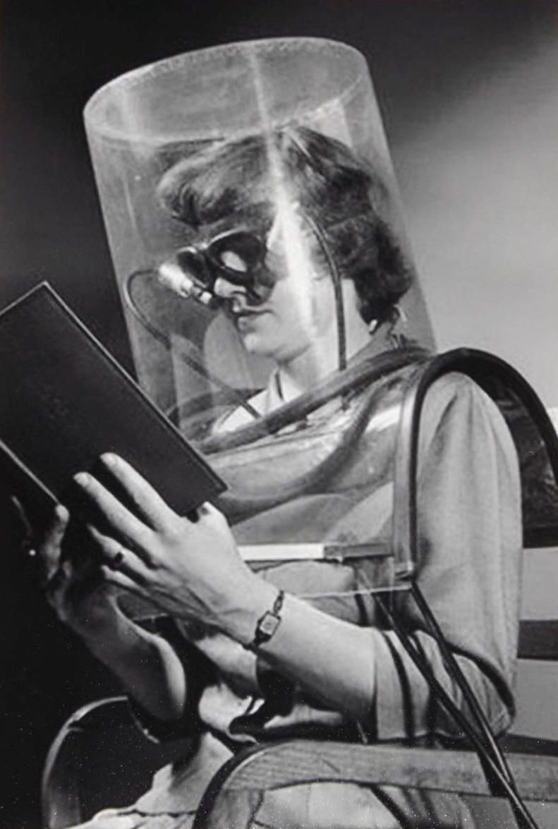 A model shows off a special invention to help someone focus on reading a book in the US in 1940.
