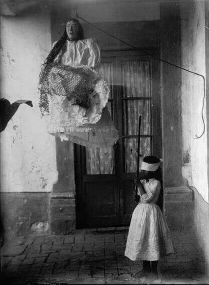 A young girl prepares to destroy a pinata in Mexico in 1929.