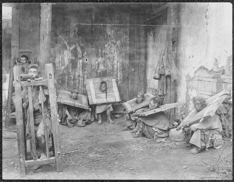 Criminals locked up in special devices in China in 1890.