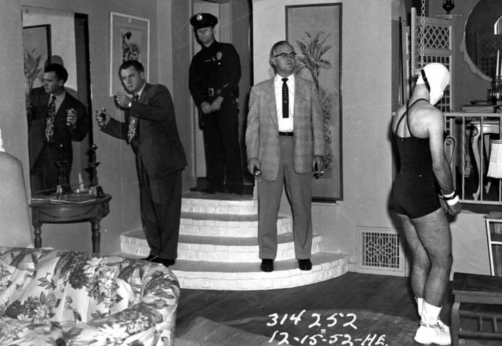 Police look for clues in a home of a man who accidentally hung himself during a BDSM sessions with his girlfriend in LA, US in 1952.